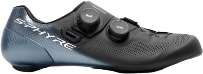 A black Shimano S-PHYRE RC903 cycling shoe with white branding, featuring a micro-fiber leather upper and three cleat mounts on the sole.