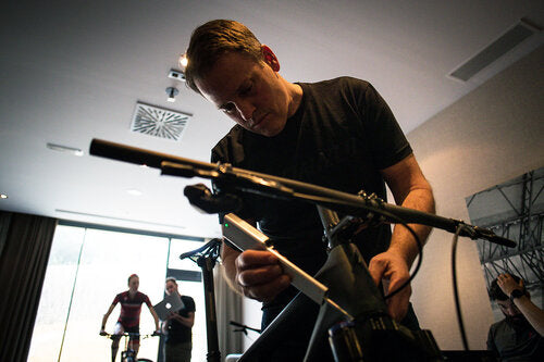Bike fitter taking measurements