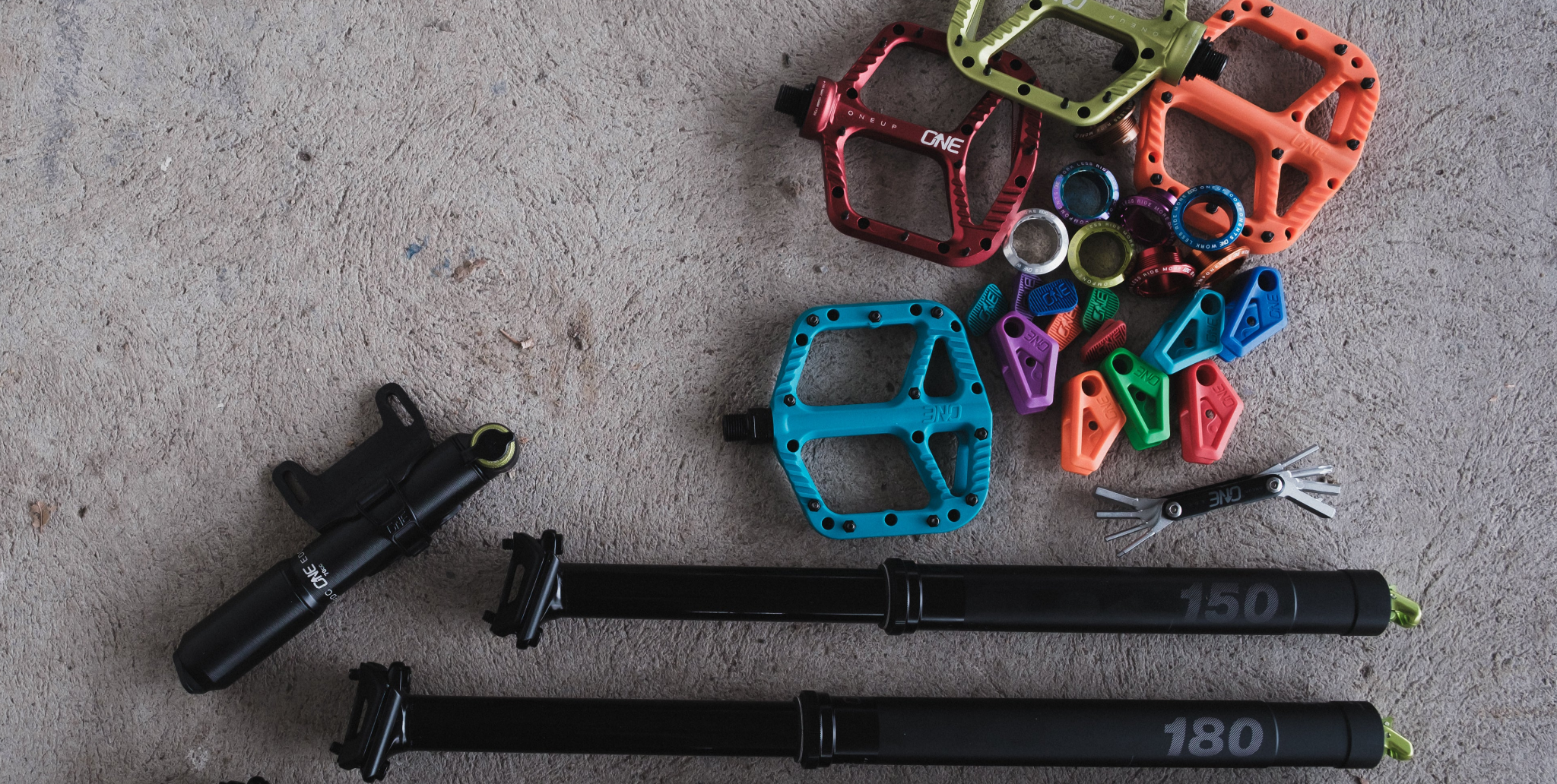 Colorful bike pedals and cranks on a gray surface